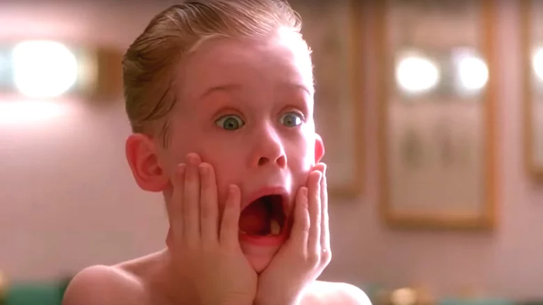 Kevin McCallister from Home Alone holding his face in shock with wide eyes and an open mouth in the iconic bathroom scene.