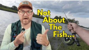 Jeff Turner smiling and giving a thumbs up while fly fishing by a river, with bold text reading "Not About The Fish" for the video on life lessons from fishing