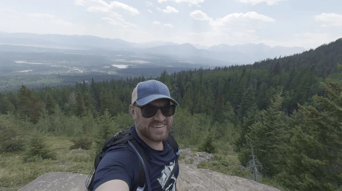 Jeff Turner smiling on a mountain hiking trail